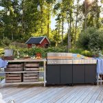 Bluegaz Z Gasolgrill plus Z Sidomodul på trädäck med röd stuga i bakgrunden